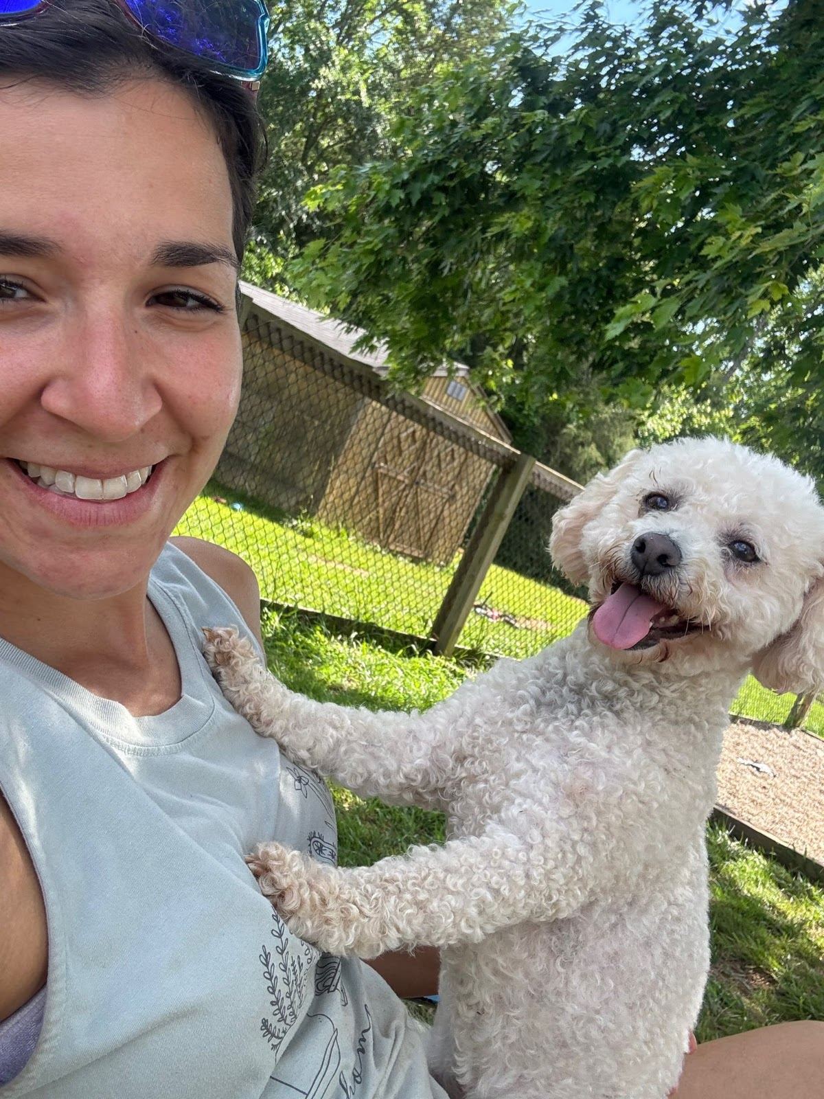 Roslyn of Devoted Dog Care outside with a happy doodle